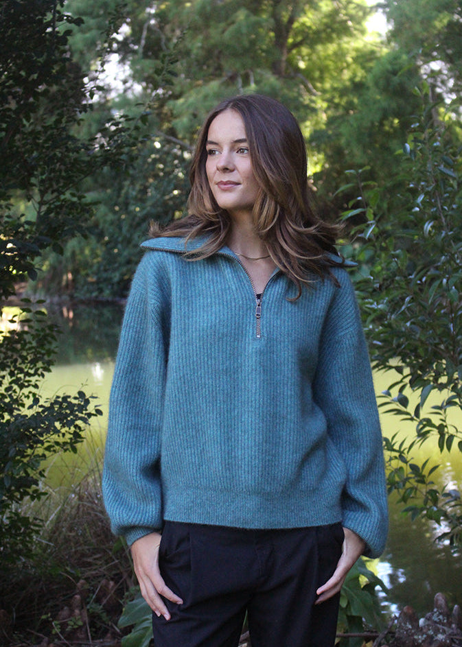 Teal womans quarter-zip Merino Possum jersey with rib detail.