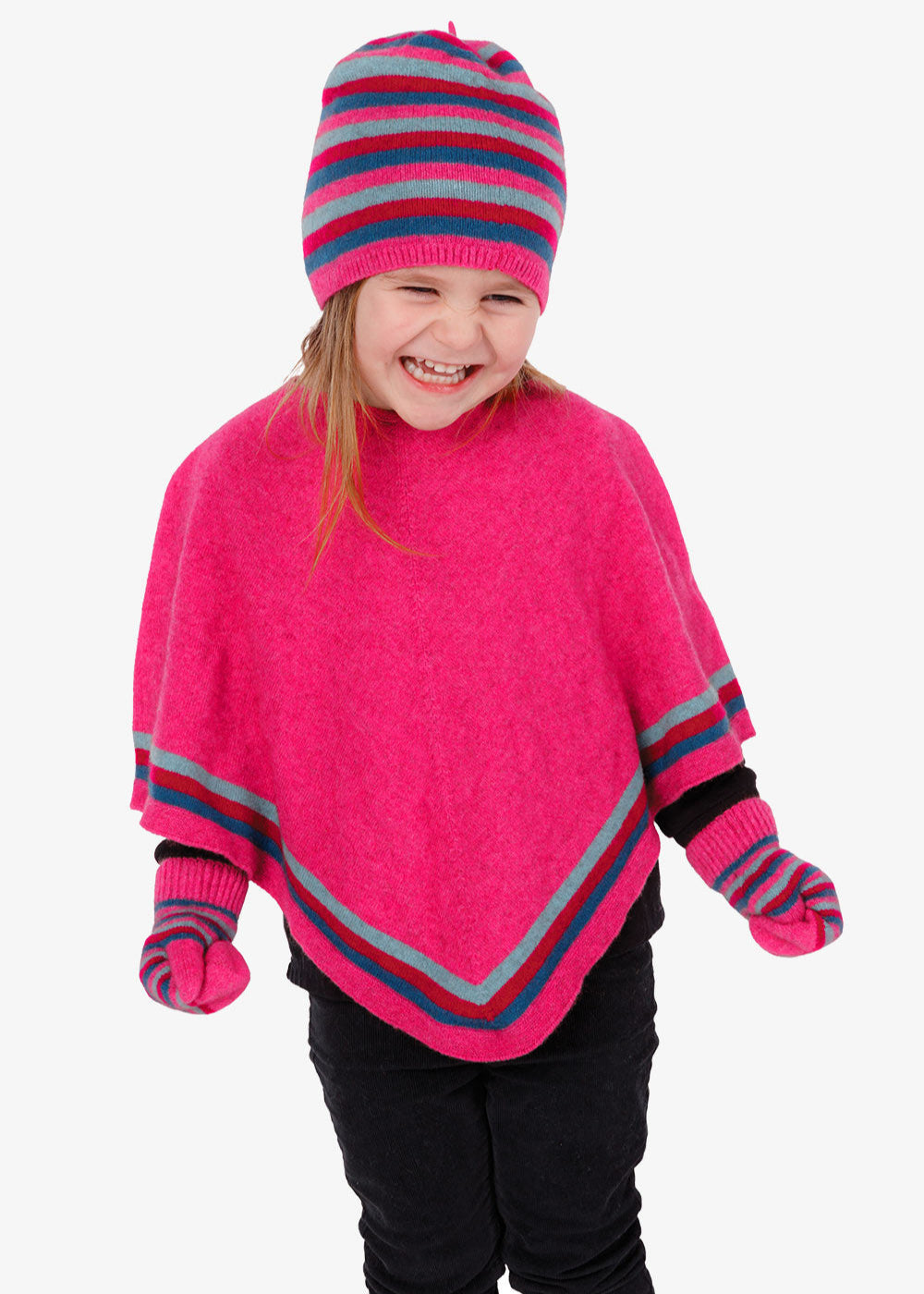 Child wearing a bright pink poncho and striped hat on a white background