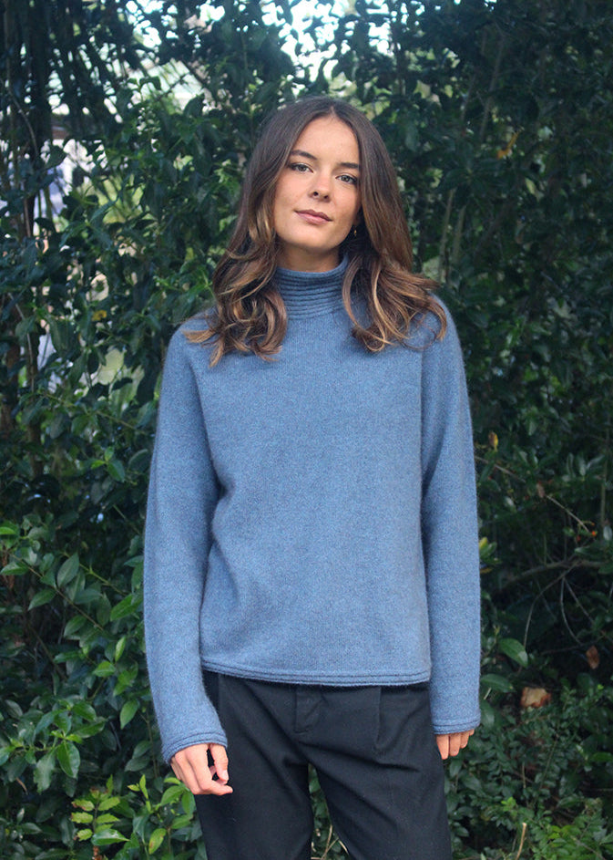 Light Blue Merino Possum Turtle neck jersey with neck, cuff and hem detail.