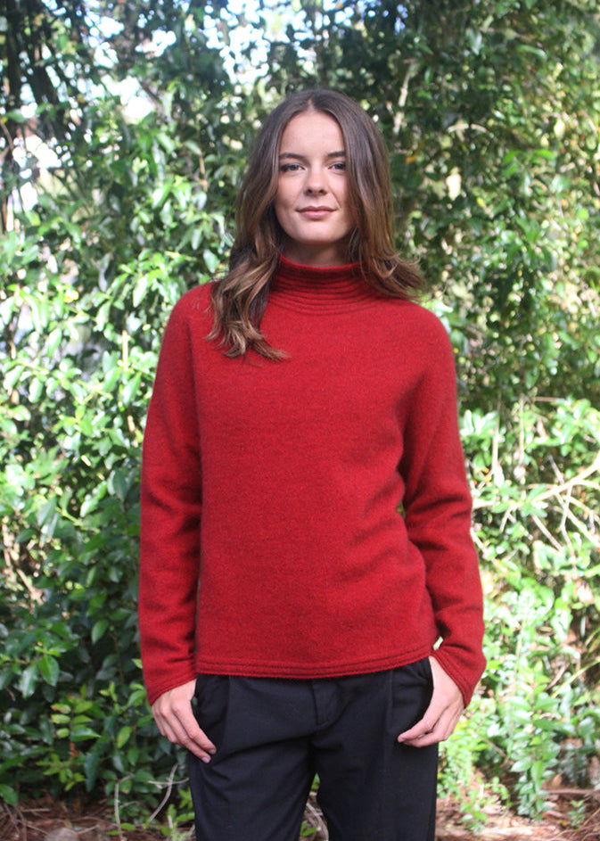 Red Merino Possum Turtle neck jersey with neck, cuff and hem detail.