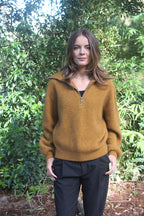 Gold woman's quarter-zip Merino Possum jersey with rib detail. 