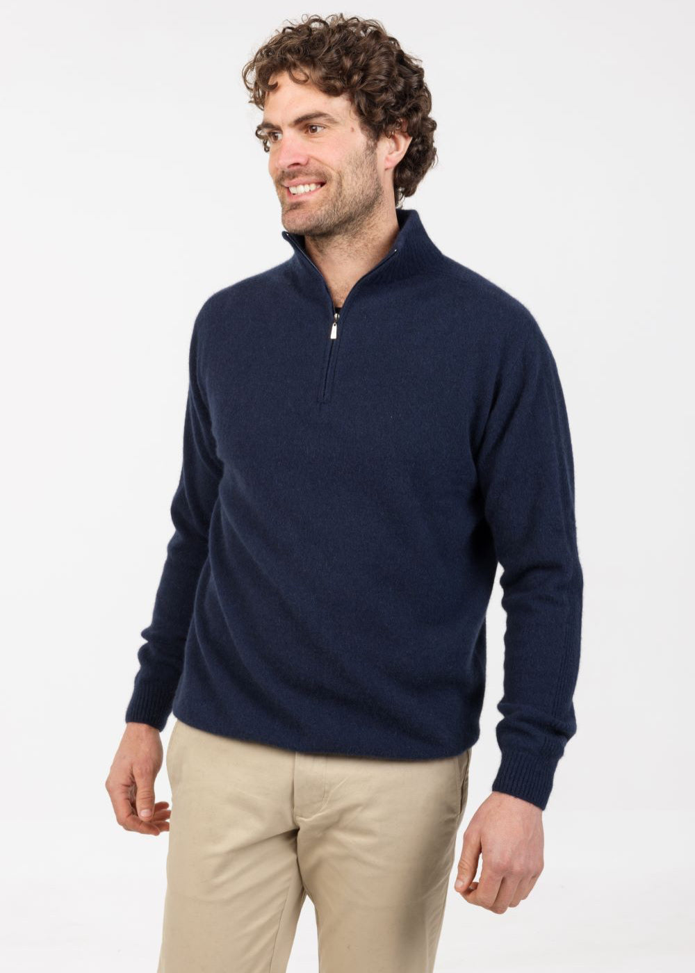 Man wearing a navy blue pullover with a zipper . Merino, possum made in New Zealand.